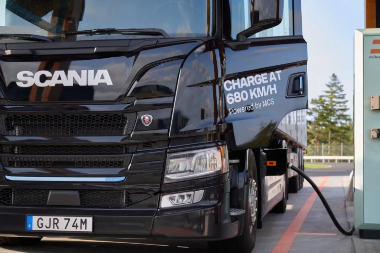 Scania battery-electric heavy truck connected to a Megawatt Charging System dispenser during a vehicle-to-grid bi-directional power transfer demonstration
