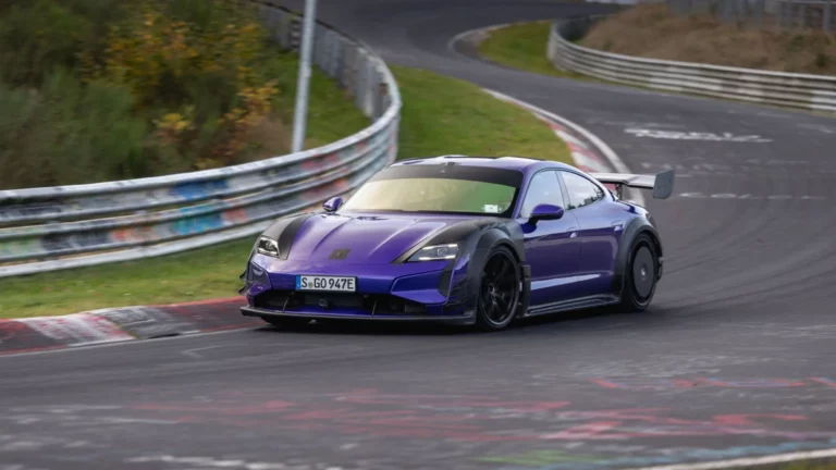 Purple Porsche Taycan Turbo GT with Weissach Package and Manthey Kit cornering on the Nürburgring-Nordschleife, setting a 6:55.553 Electric Executive Cars lap record.