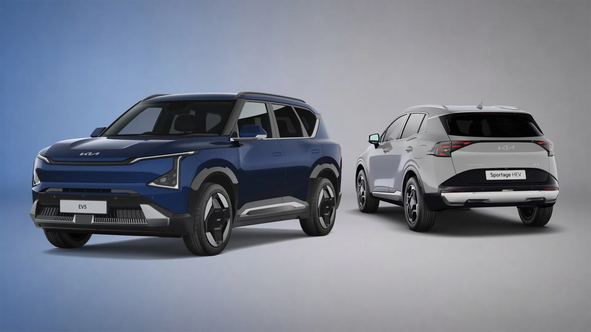 Kia EV5 in Dark Ocean Blue and Kia Sportage HEV in silver, shown side by side in studio setting