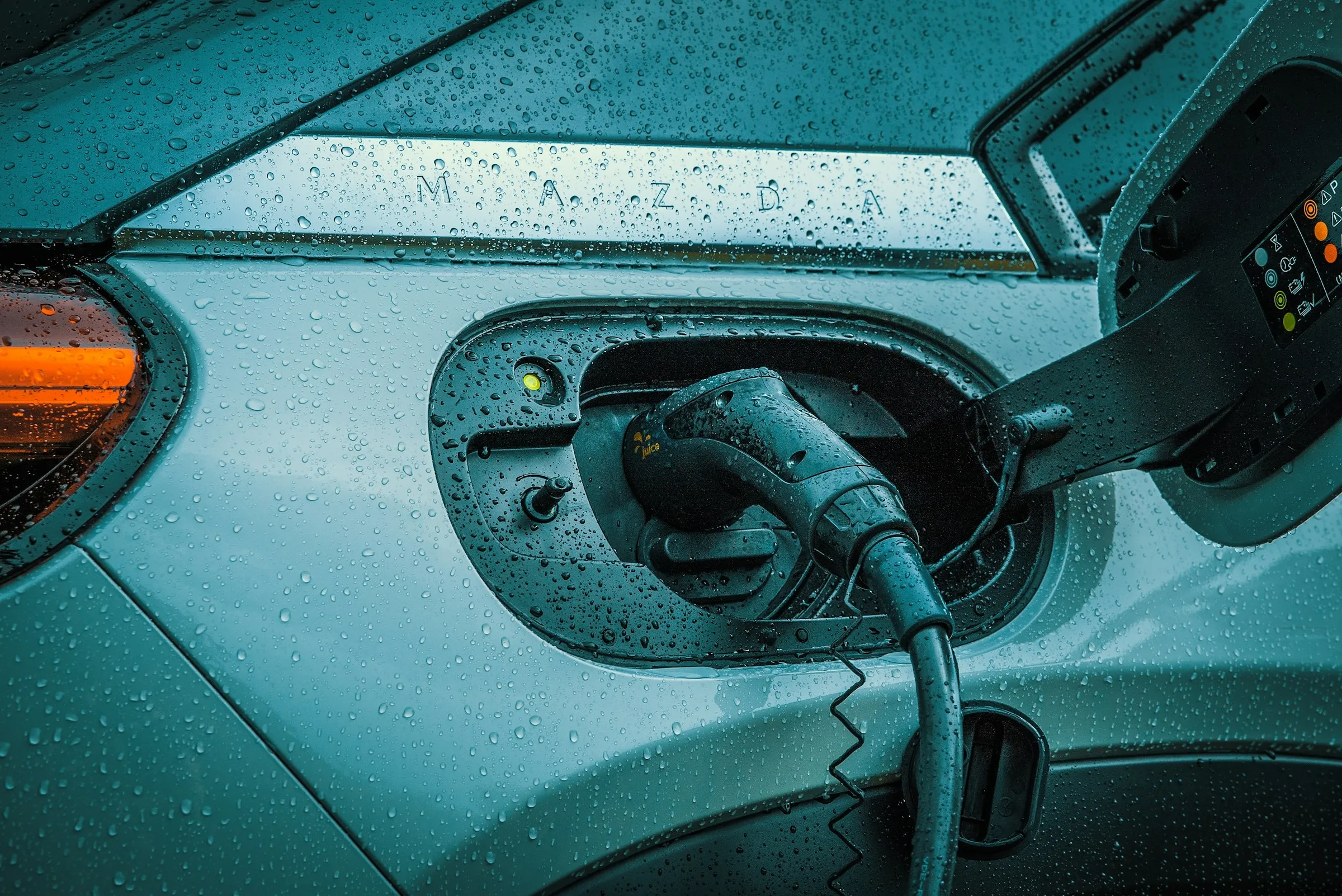 Electric vehicle plugged in and charging, illustrating EV All Day's new used-EV battery health check