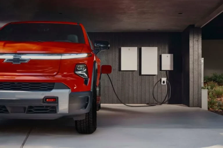 GM Energy V2H Bundle plugged into a 2026 Chevrolet Silverado EV Trail Boss in a home garage