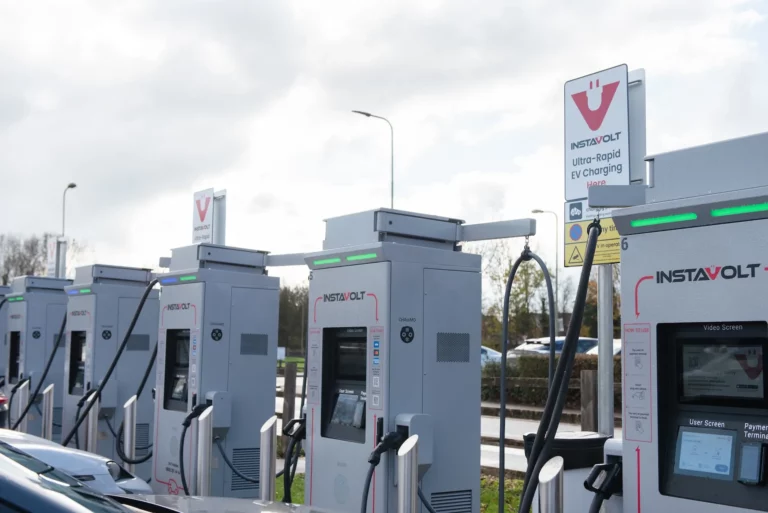 Row of InstaVolt ultra-rapid EV charging stations in the UK, where the company is redirecting capital after selling its Spain and Portugal business to Powerdot