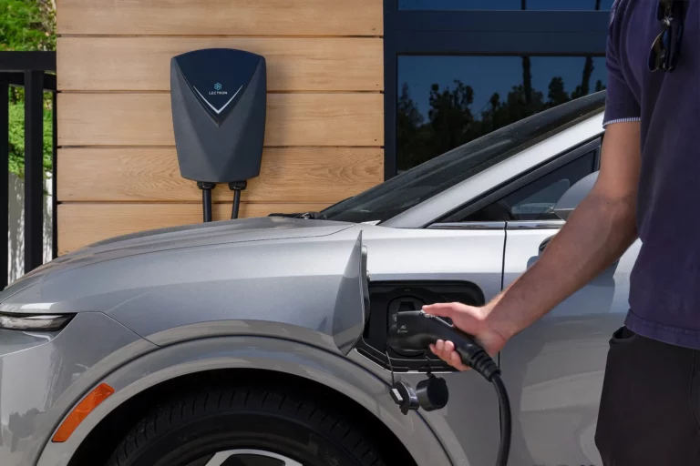 Lectron Nexus home EV charger mounted on a wall with charging cable coiled on the J-hook holster