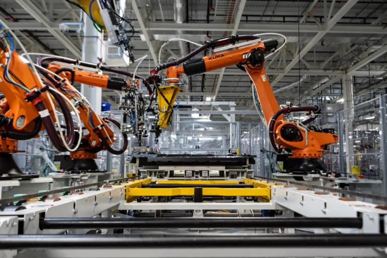 Workers and robots assemble a Gen6 high-voltage battery on the line at BMW Group Plant Woodruff in South Carolina.