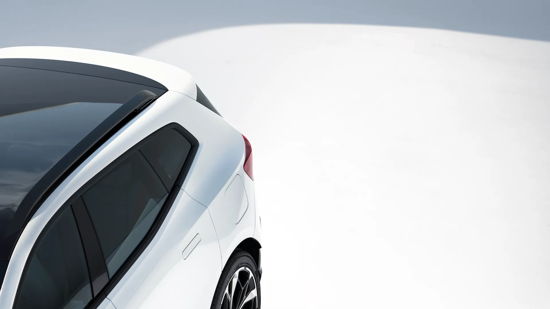 White Polestar 4 SUV viewed from above, showing the roofline, rear spoiler, and tailgate design