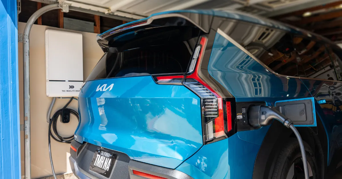 Driver plugs in an EV participating in a Massachusetts vehicle-to-grid program using Sunrun smart charging technology
