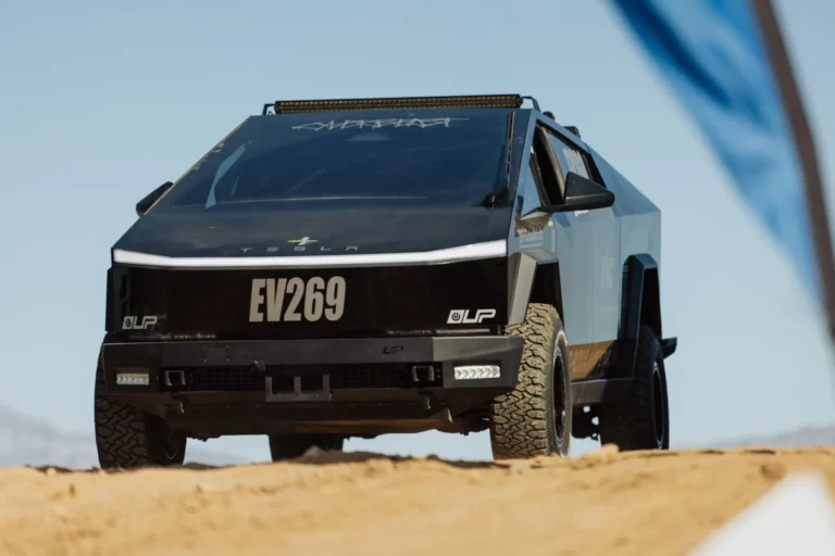UP INVINCIBLE 2.5-inch lift kit installed on a Tesla Cybertruck showing raised ground clearance