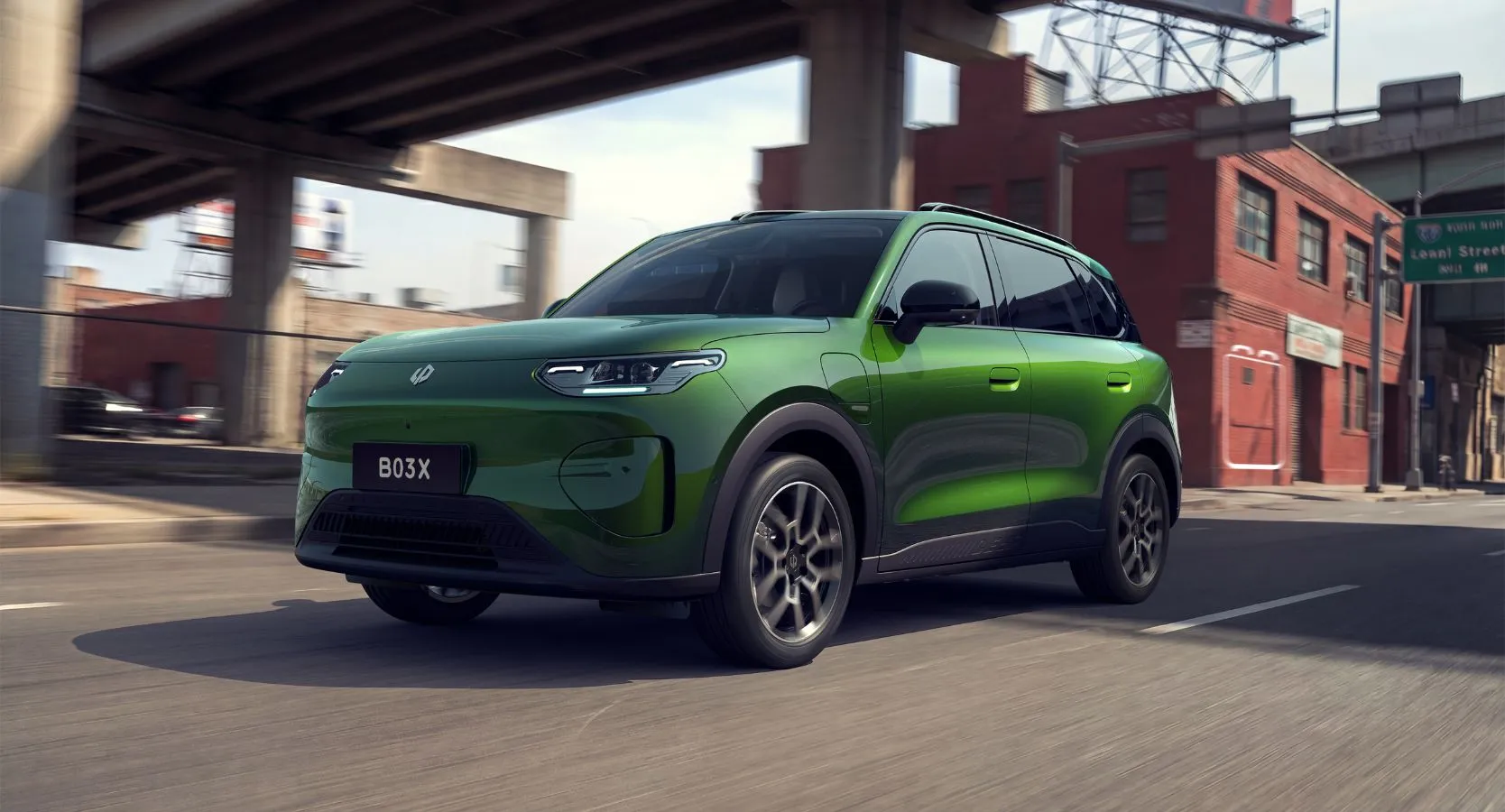 Green Leapmotor B03X electric urban crossover driving on a city street beneath an overpass
