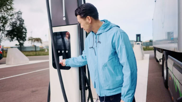 Driver using an EV charging station, illustrating fleet EV charging access through the Piana and GreenFlux partnership