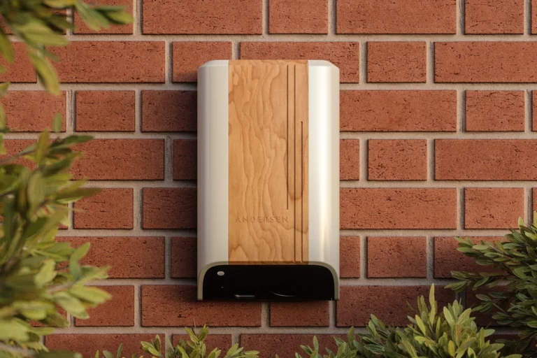 Andersen Quartz EV charge point in a premium wood finish mounted on a residential exterior wall
