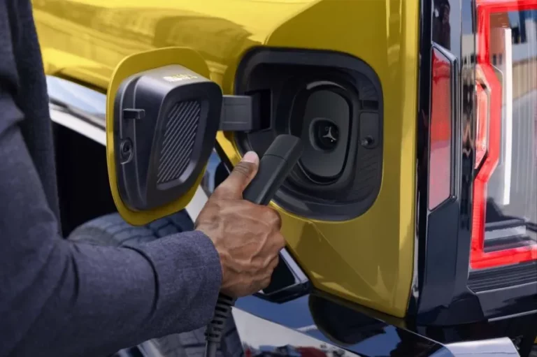Native North American Charging Standard (NACS) inlet on a GMC Hummer EV, part of GM's transition to native NACS ports across its EV lineup