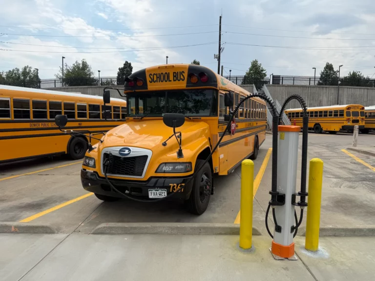 Blue Bird Vision electric school bus connected to a Kempower Satellite dispenser for electric school bus charging at the Denver Public Schools Hilltop Bus Terminal