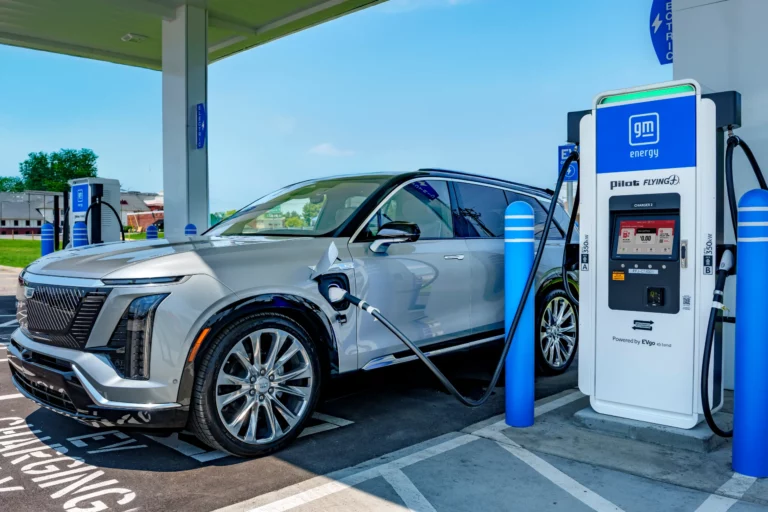 An electric vehicle charging under a canopy at a Pilot, GM and EVgo fast-charging location