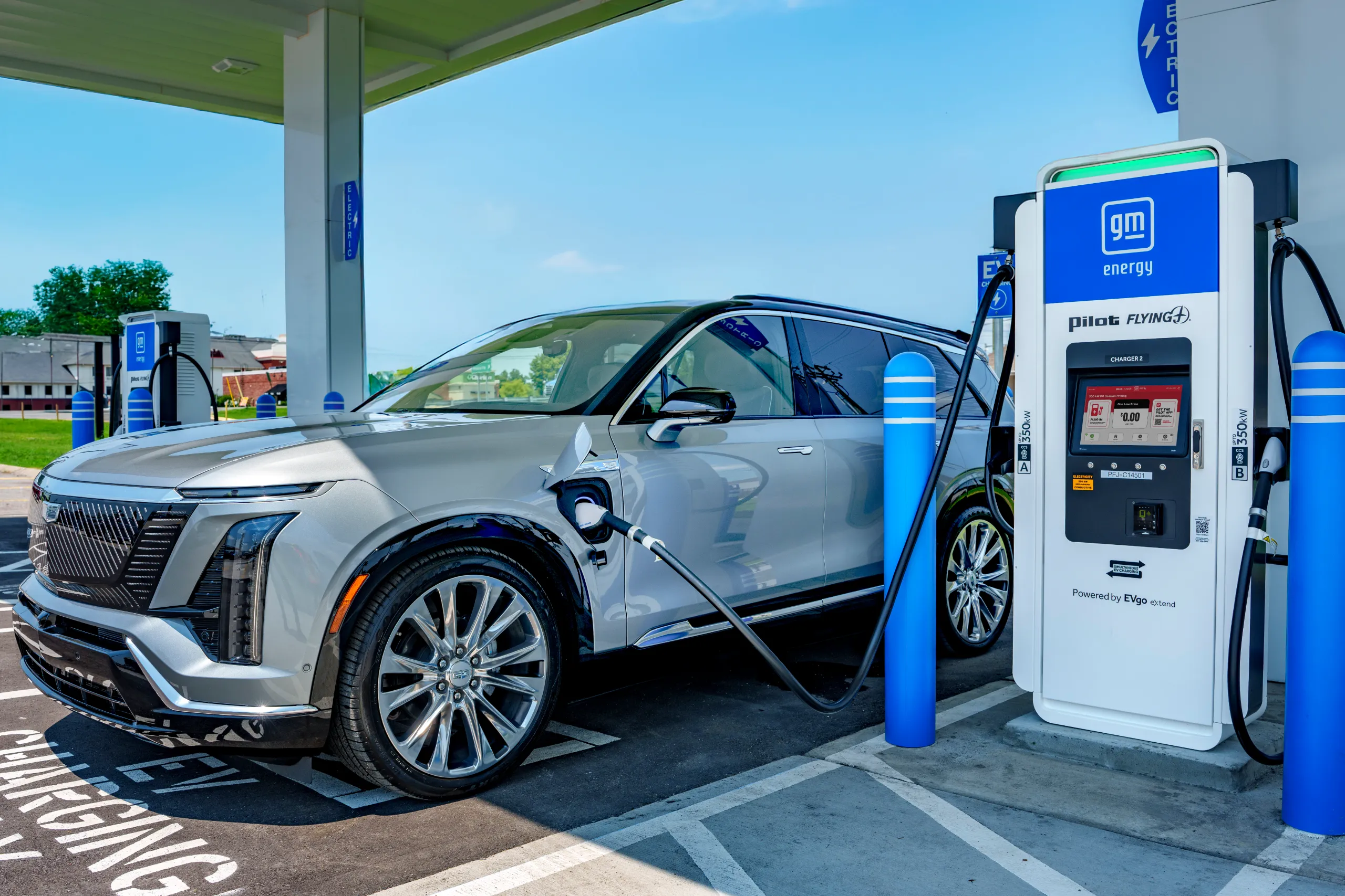 An electric vehicle charging under a canopy at a Pilot, GM and EVgo fast-charging location