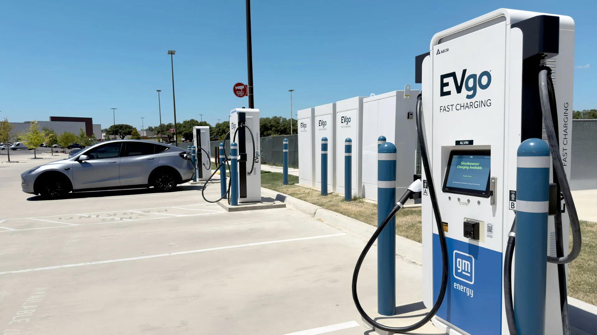 EVgo fast charging stalls installed at a Brixmor shopping center parking lot
