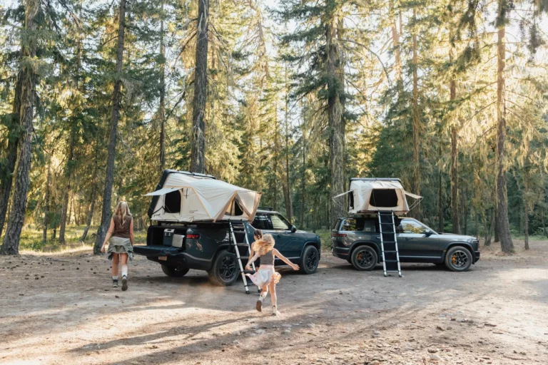 Rivian iKamper Skycamp 4.0 DLX rooftop tent deployed on a Rivian electric vehicle at a remote campsite