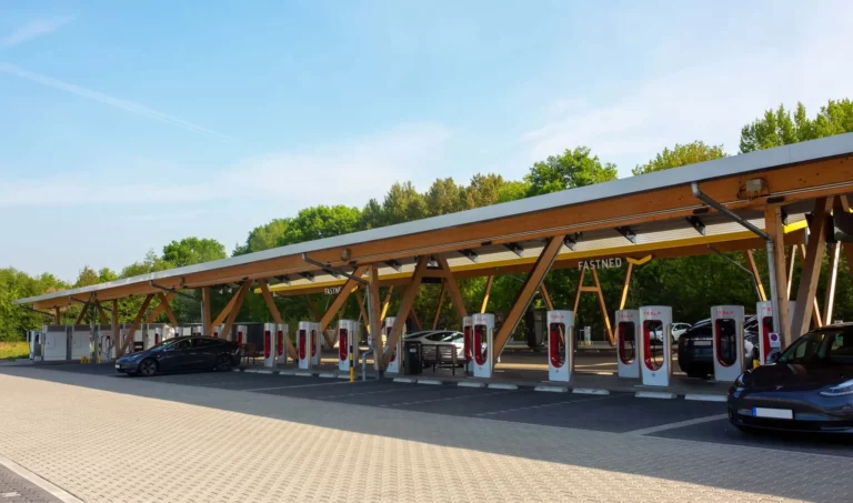 Fast EV charging station canopy with multiple chargers, illustrating TomTom EV charging data coverage growth.