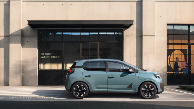 Second-generation Dacia Spring electric car in Agave green, front three-quarter view showing black trim strip linking the headlights