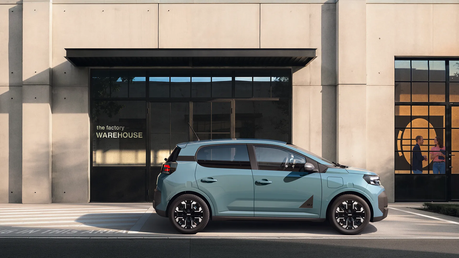 Second-generation Dacia Spring electric car in Agave green, front three-quarter view showing black trim strip linking the headlights