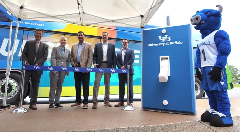 University at Buffalo electric buses parked on campus as officials from UB, WeDriveU and Zenobē mark the Stampede fleet's first battery-electric transit vehicles.