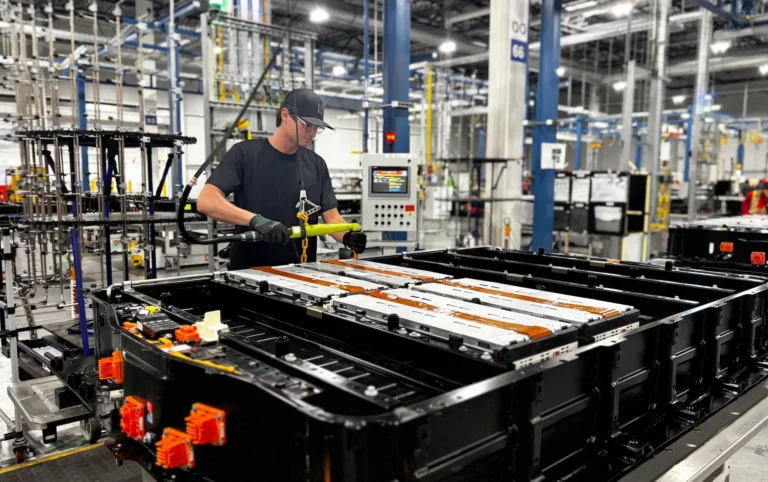 GM team member installing battery modules made with recycled cathode material into a new pack at Factory ZERO as part of the closed-loop EV battery recycling pilot
