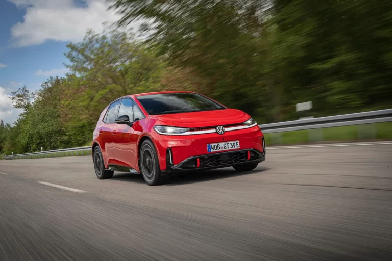 Front three-quarter view of the Volkswagen ID.3 GTI electric hatchback in Tornado Red with red front stripe and 20-inch Wörthersee wheels