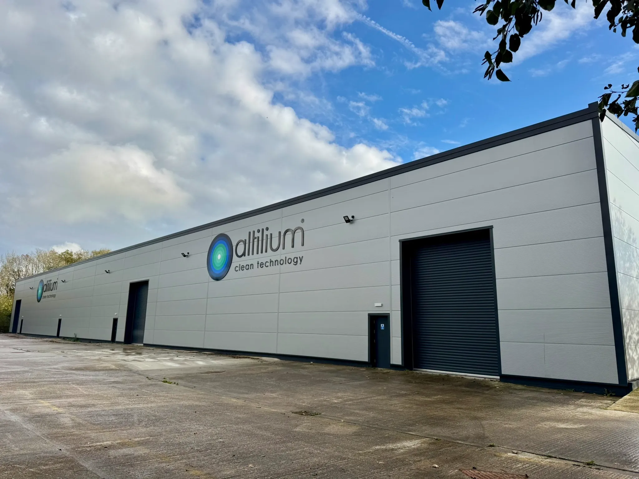 Exterior of Altilium's battery recycling facility with "altilium clean technology" signage and loading bays