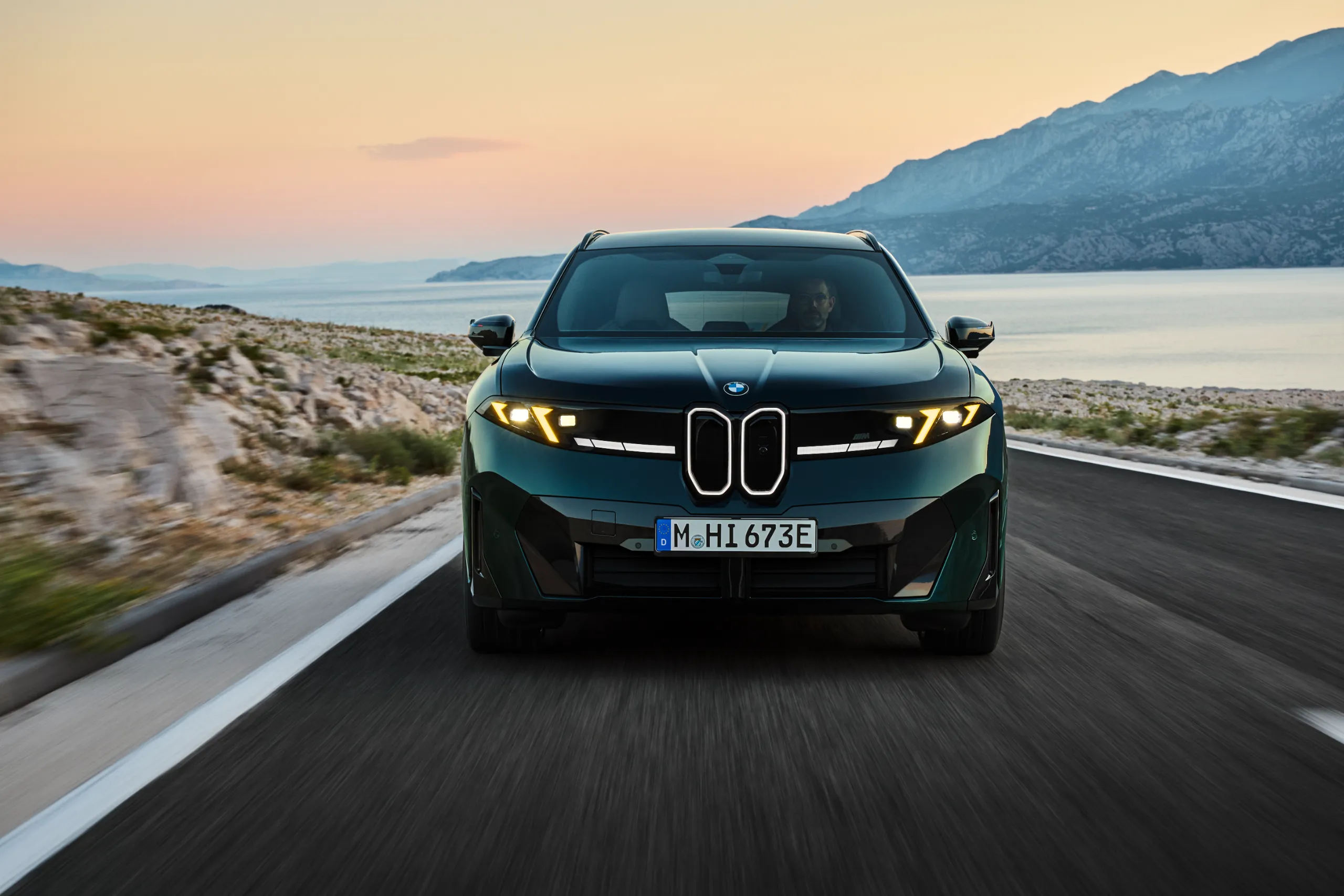 BMW iX3 M60 xDrive electric SUV front view showing M Yellow Lights and illuminated kidney grille
