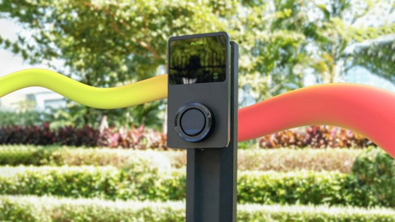 Pedestal-mounted EV charger in a landscaped setting, illustrating Roam's EV charger replacement program